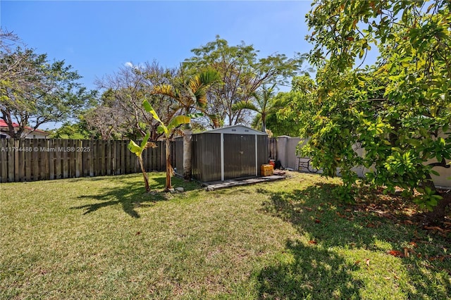 view of yard with an outbuilding, a shed, and a fenced backyard