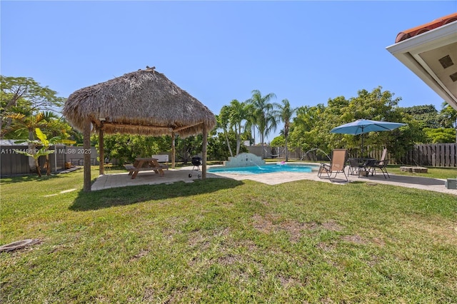 view of yard with a gazebo, a fenced backyard, a fenced in pool, and a patio