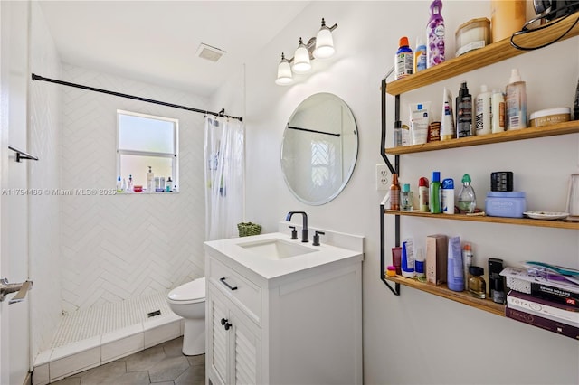 bathroom featuring visible vents, vanity, toilet, tile patterned floors, and a stall shower