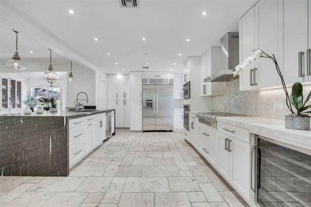 1161 Sunset Dr, Coral Gables, FL 33143 - kitchen featuring appliances with stainless steel finishes, wall chimney exhaust hood, a sink, beverage cooler, and recessed lighting