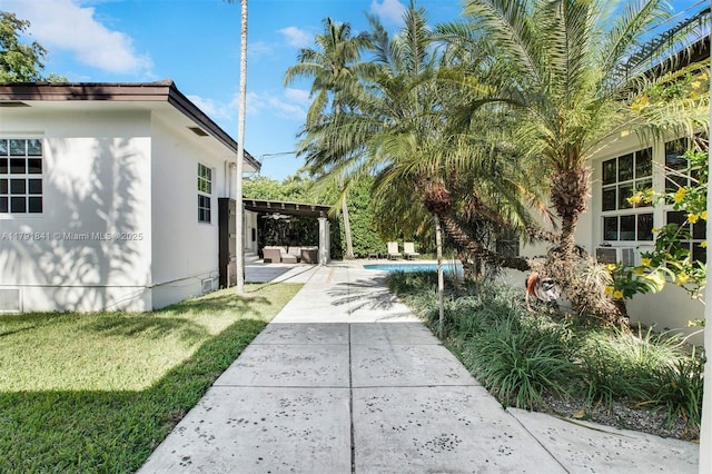 1161 Sunset Dr, Coral Gables, FL 33143 - view of grassy yard with an outdoor pool, a pergola, and a patio area