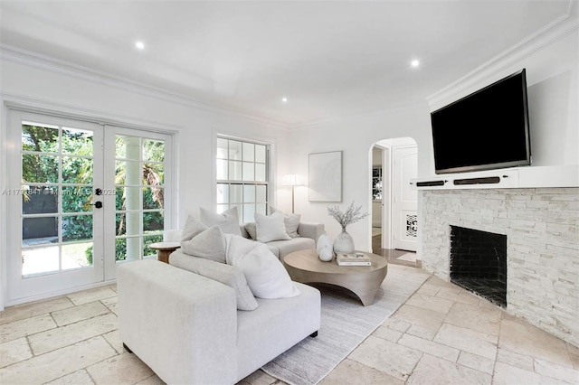 1161 Sunset Dr, Coral Gables, FL 33143 - living room with arched walkways, stone tile flooring, ornamental molding, recessed lighting, and a fireplace