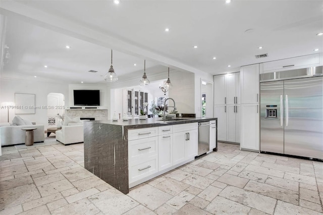 1161 Sunset Dr, Coral Gables, FL 33143 - kitchen with stainless steel appliances, a sink, open floor plan, backsplash, and white cabinets
