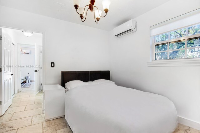1161 Sunset Dr, Coral Gables, FL 33143 - bedroom with an AC wall unit, a chandelier, stone tile flooring, and baseboards