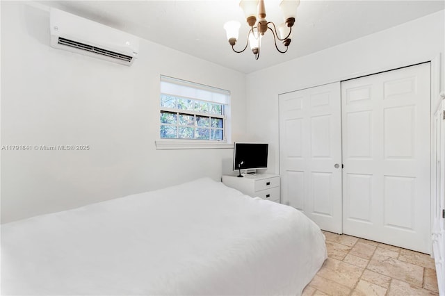 1161 Sunset Dr, Coral Gables, FL 33143 - bedroom featuring a chandelier, a wall mounted AC, stone tile floors, and a closet