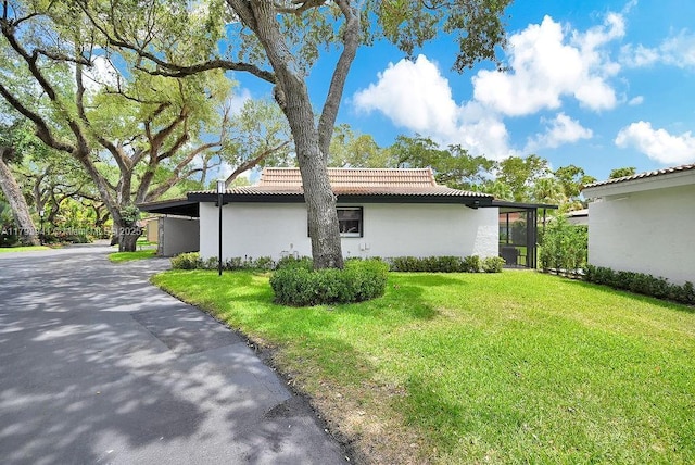 3501 Keyser Ave Unit 43, Hollywood, FL 33021 - view of home's exterior with a tiled roof, a yard, and stucco siding