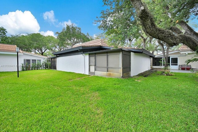 3501 Keyser Ave Unit 43, Hollywood, FL 33021 - rear view of property featuring stucco siding and a yard