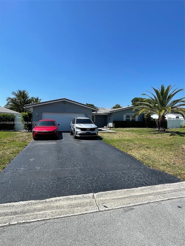 8588 NW 27th Dr, Coral Springs, FL 33065 - single story home featuring aphalt driveway and a front yard