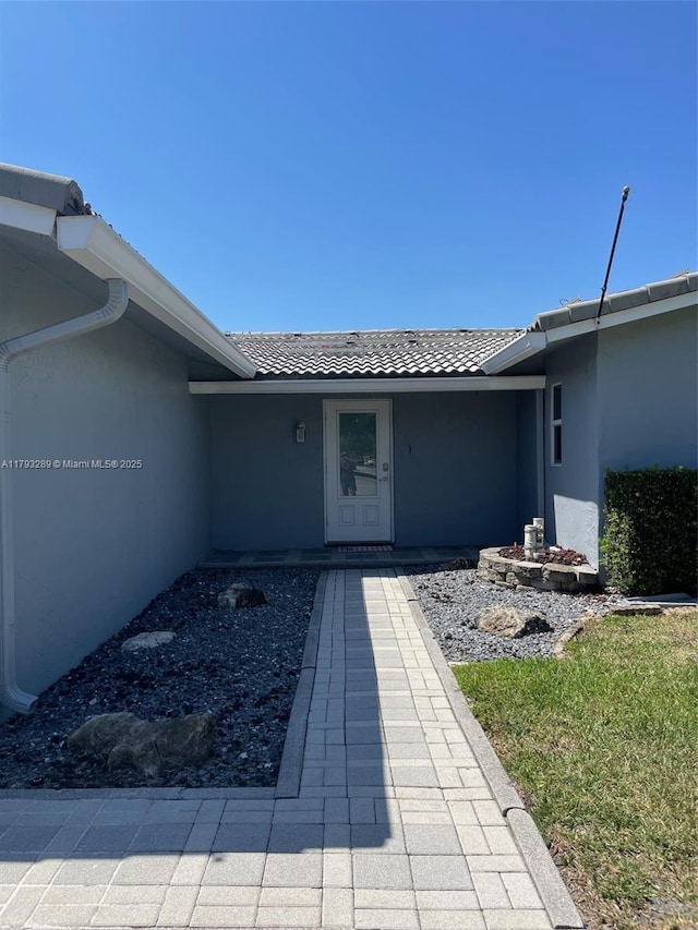 8588 NW 27th Dr, Coral Springs, FL 33065 - entrance to property featuring stucco siding and a tiled roof