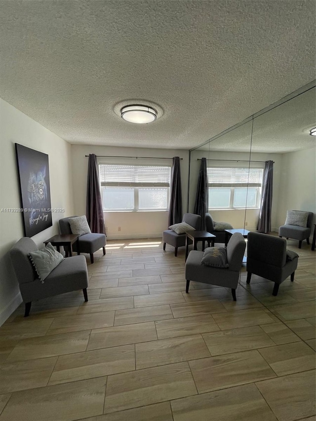 8588 NW 27th Dr, Coral Springs, FL 33065 - living area with wood tiled floor and a textured ceiling