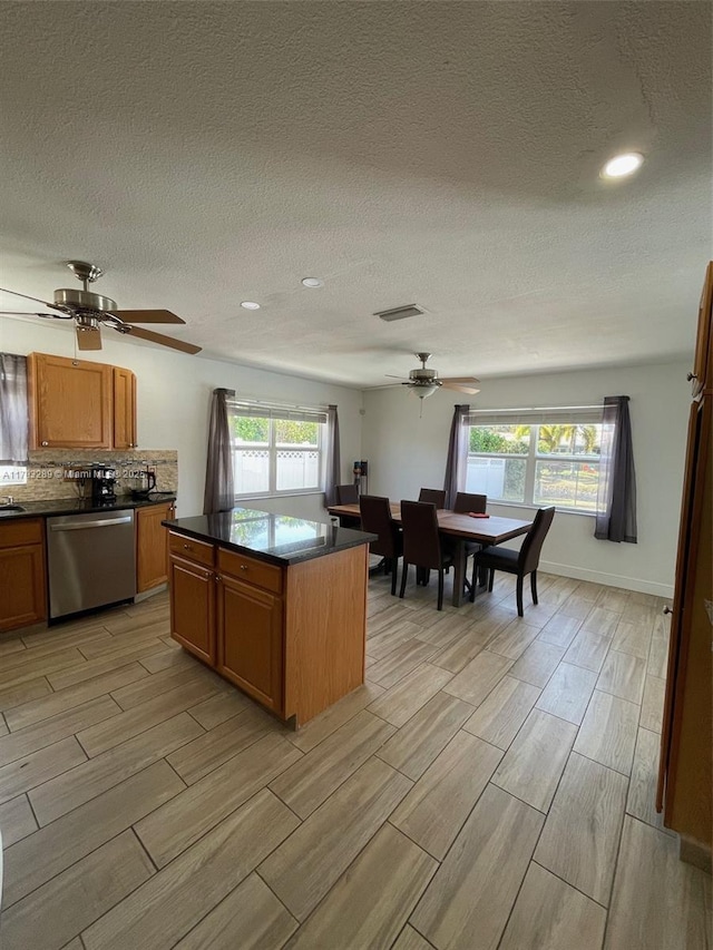 8588 NW 27th Dr, Coral Springs, FL 33065 - kitchen with dark countertops, dishwasher, a ceiling fan, wood tiled floor, and visible vents