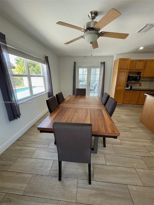 8588 NW 27th Dr, Coral Springs, FL 33065 - dining room with visible vents, baseboards, ceiling fan, wood finish floors, and french doors