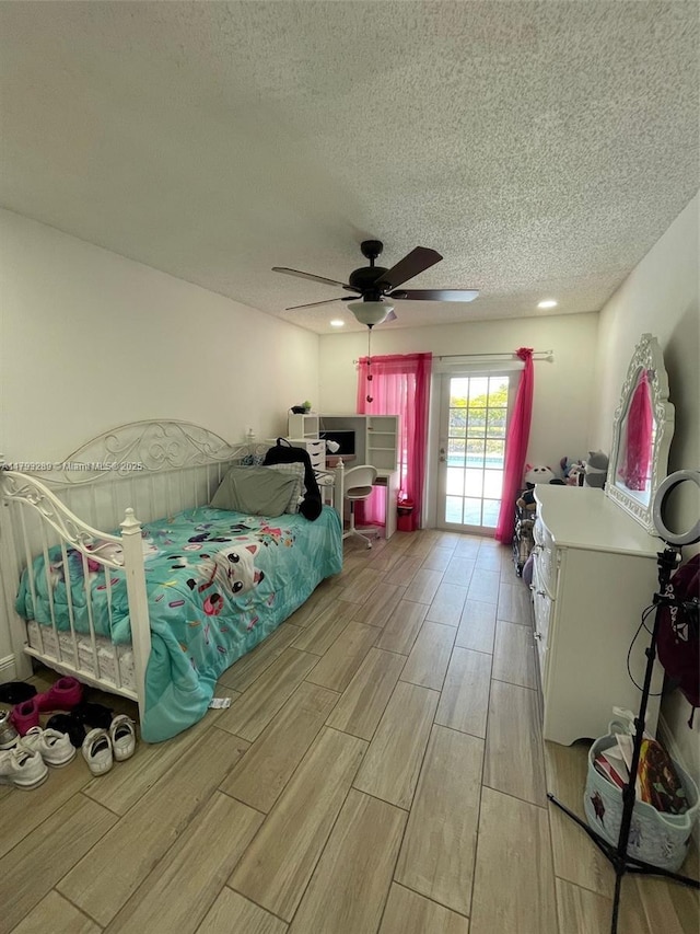 8588 NW 27th Dr, Coral Springs, FL 33065 - bedroom featuring access to outside, a ceiling fan, a textured ceiling, and wood finish floors