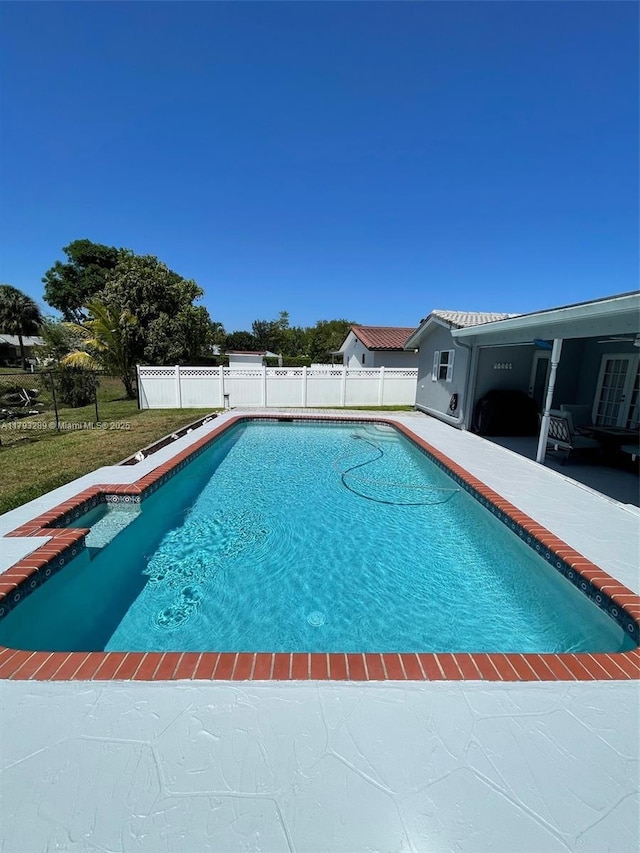 8588 NW 27th Dr, Coral Springs, FL 33065 - view of swimming pool featuring a fenced in pool, a patio area, and fence