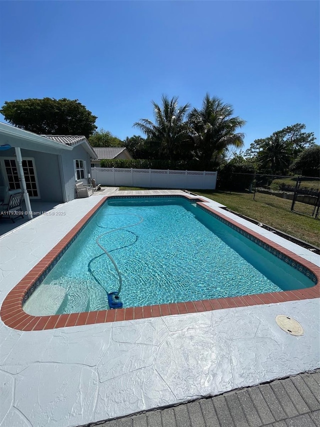 8588 NW 27th Dr, Coral Springs, FL 33065 - view of swimming pool featuring a fenced backyard, a fenced in pool, and a patio