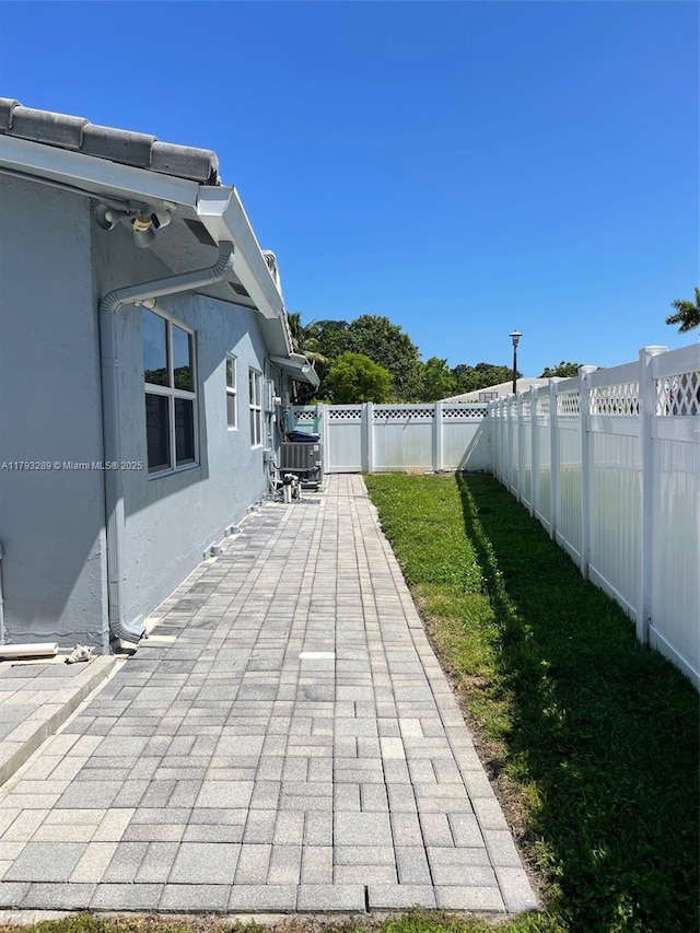 8588 NW 27th Dr, Coral Springs, FL 33065 - view of patio / terrace featuring a fenced backyard and central AC