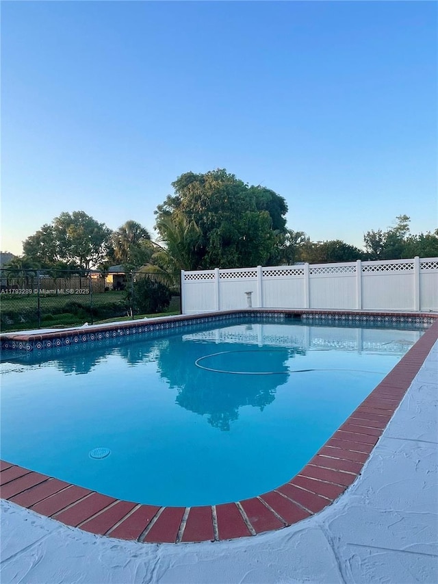 8588 NW 27th Dr, Coral Springs, FL 33065 - view of swimming pool featuring a fenced backyard and a fenced in pool
