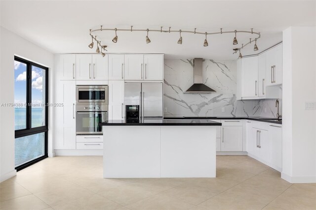 1600 S Bayshore Ln Unit 8D, Coconut Grove, FL 33133 - kitchen with stainless steel appliances, wall chimney exhaust hood, tasteful backsplash, and white cabinets