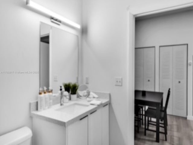 136 NW 26th St Unit 503, Miami, FL 33127 - bathroom with vanity, toilet, and wood finished floors