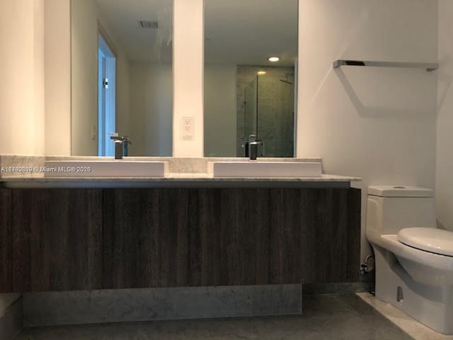 801 S Miami Ave Unit 2505, Miami, FL 33130 - full bath with visible vents, double vanity, toilet, a sink, and a stall shower
