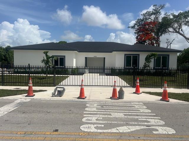 11870 SW 220th St, Miami, FL 33170 - ranch-style home featuring stucco siding, a garage, and a fenced front yard
