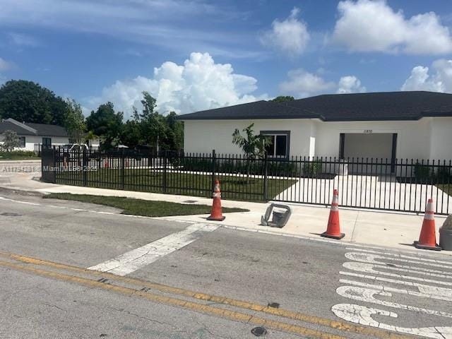 11870 SW 220th St, Miami, FL 33170 - view of front of house with a garage and stucco siding