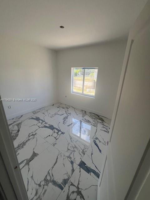 11870 SW 220th St, Miami, FL 33170 - empty room with baseboards and marble finish floor