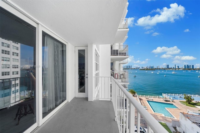 balcony featuring a city view and a water view