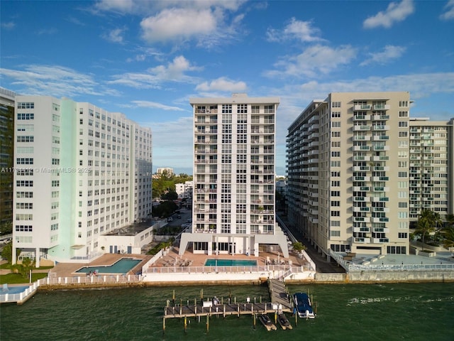 view of building exterior with a water view and a view of city