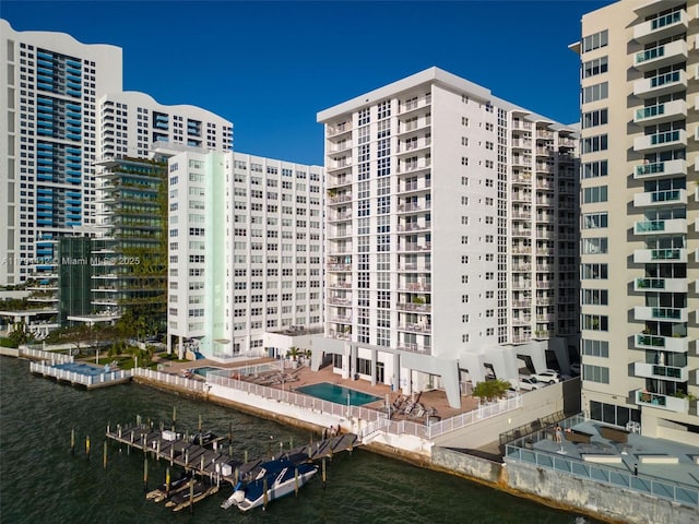 view of building exterior featuring a view of city and a water view