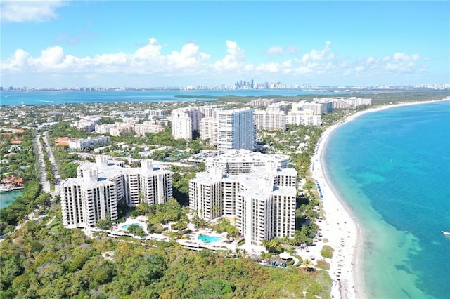 drone / aerial view featuring a city view, a beach view, and a water view