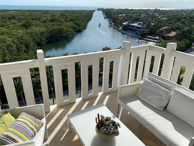 balcony with a water view and outdoor lounge area