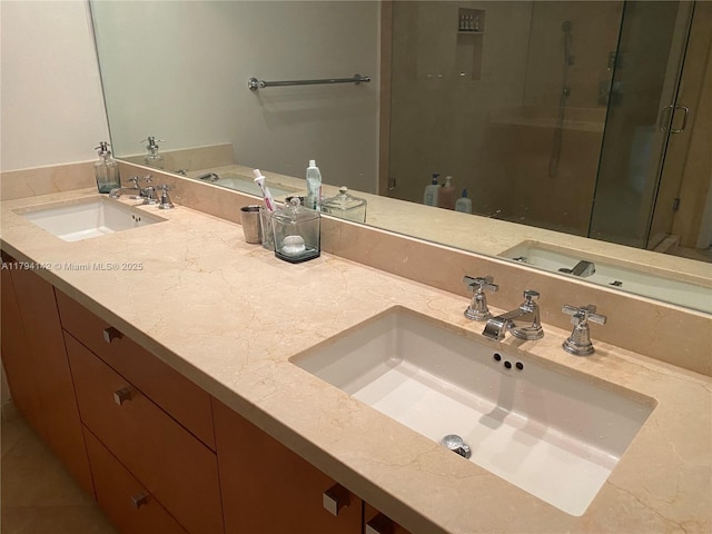full bathroom with double vanity, a sink, and a shower stall