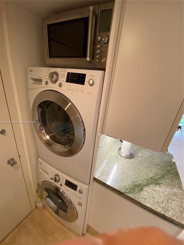 washroom with laundry area and stacked washer and clothes dryer
