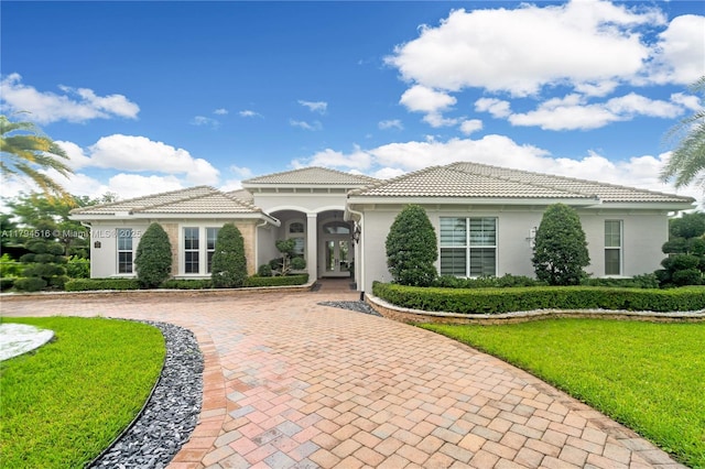 5202 S Sterling Ranch Cir, Davie, FL 33314 - mediterranean / spanish house with stucco siding, a tile roof, and a front lawn