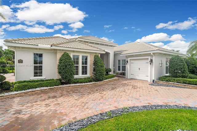 5202 S Sterling Ranch Cir, Davie, FL 33314 - view of front of property with an attached garage, decorative driveway, stucco siding, and a tile roof