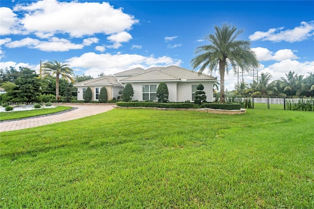 5202 S Sterling Ranch Cir, Davie, FL 33314 - mediterranean / spanish home with decorative driveway, fence, a front lawn, and stucco siding