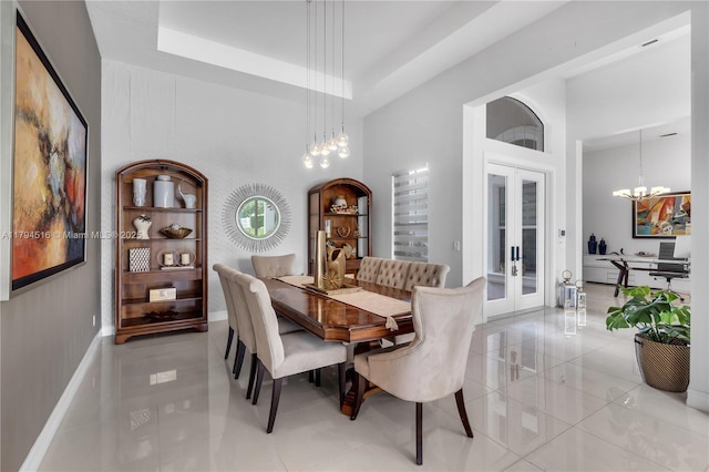 5202 S Sterling Ranch Cir, Davie, FL 33314 - dining area with french doors, a towering ceiling, light tile patterned floors, and a notable chandelier