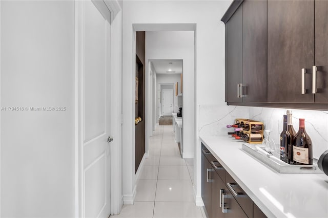 5202 S Sterling Ranch Cir, Davie, FL 33314 - bar with backsplash, baseboards, and light tile patterned floors
