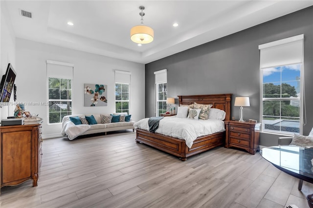 5202 S Sterling Ranch Cir, Davie, FL 33314 - bedroom with recessed lighting, a tray ceiling, visible vents, and light wood-style flooring
