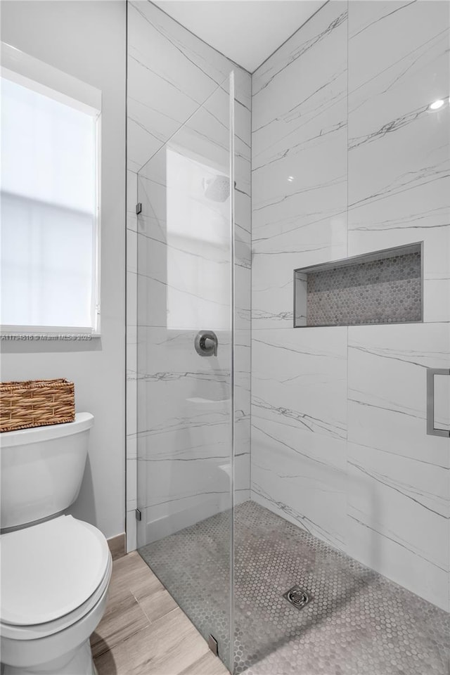 5202 S Sterling Ranch Cir, Davie, FL 33314 - bathroom featuring wood finished floors, baseboards, a stall shower, and toilet