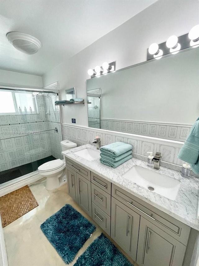 416 N Rainbow Dr, Hollywood, FL 33021 - bathroom with a shower stall, double vanity, tile walls, and wainscoting