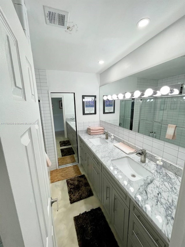 416 N Rainbow Dr, Hollywood, FL 33021 - bathroom with double vanity, decorative backsplash, a tub to relax in, and recessed lighting