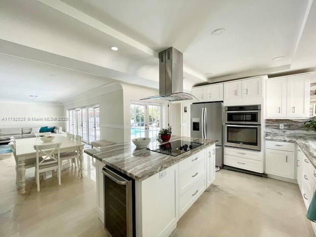 416 N Rainbow Dr, Hollywood, FL 33021 - kitchen with beverage cooler, appliances with stainless steel finishes, island exhaust hood, light stone counters, and open floor plan