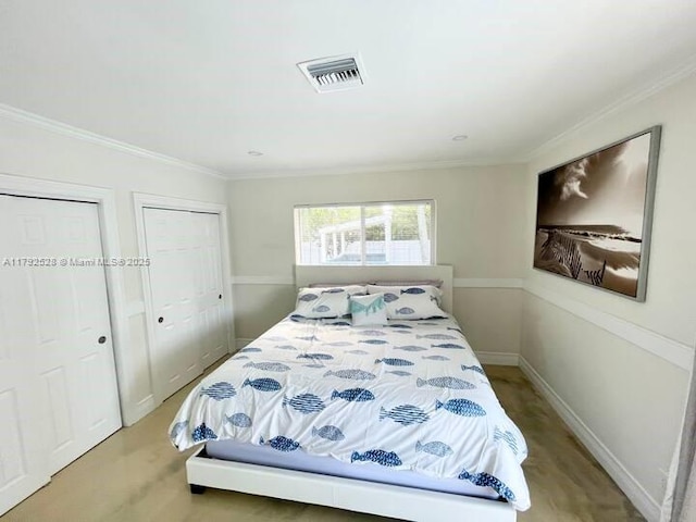 416 N Rainbow Dr, Hollywood, FL 33021 - bedroom featuring two closets, ornamental molding, and wood finished floors