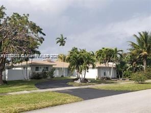 416 N Rainbow Dr, Hollywood, FL 33021 - view of front of house with a front lawn and asphalt driveway
