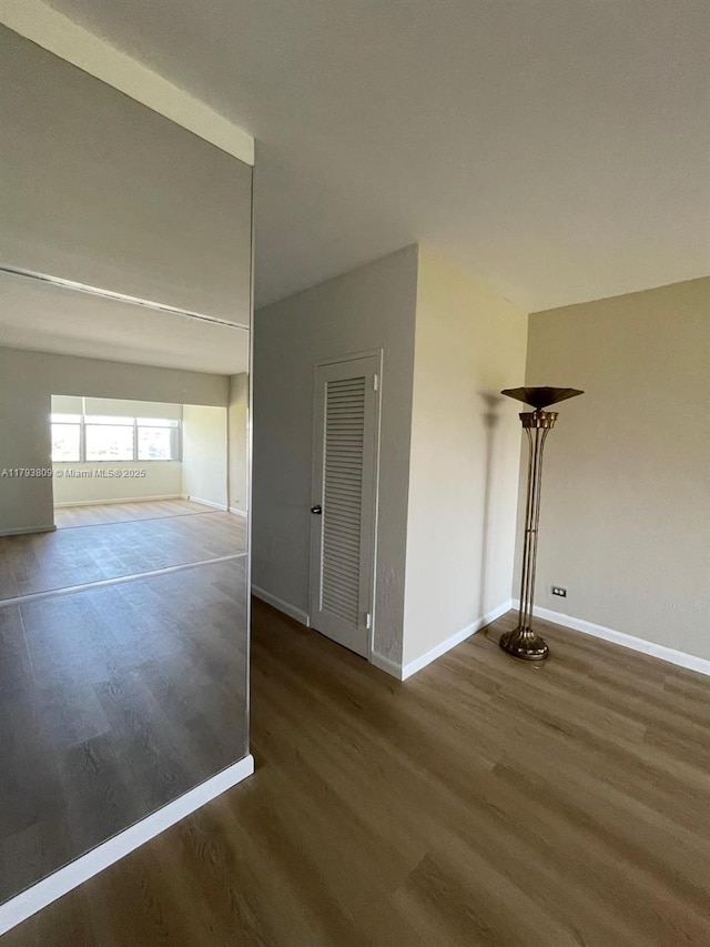 interior space featuring baseboards and wood finished floors