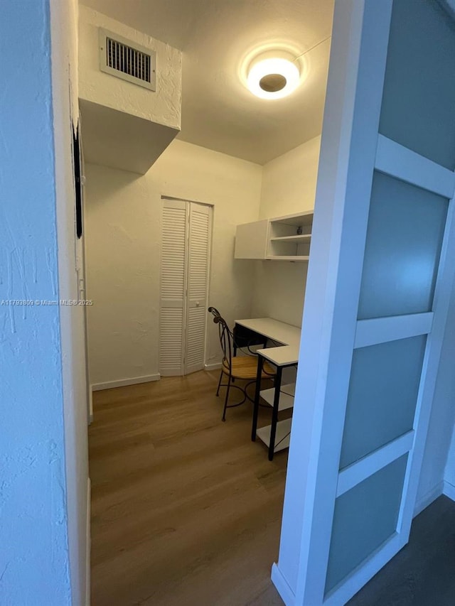 walk in closet with visible vents and wood finished floors