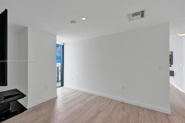 unfurnished living room with visible vents, recessed lighting, light wood-style flooring, and baseboards