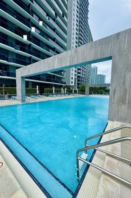 view of pool featuring a city view